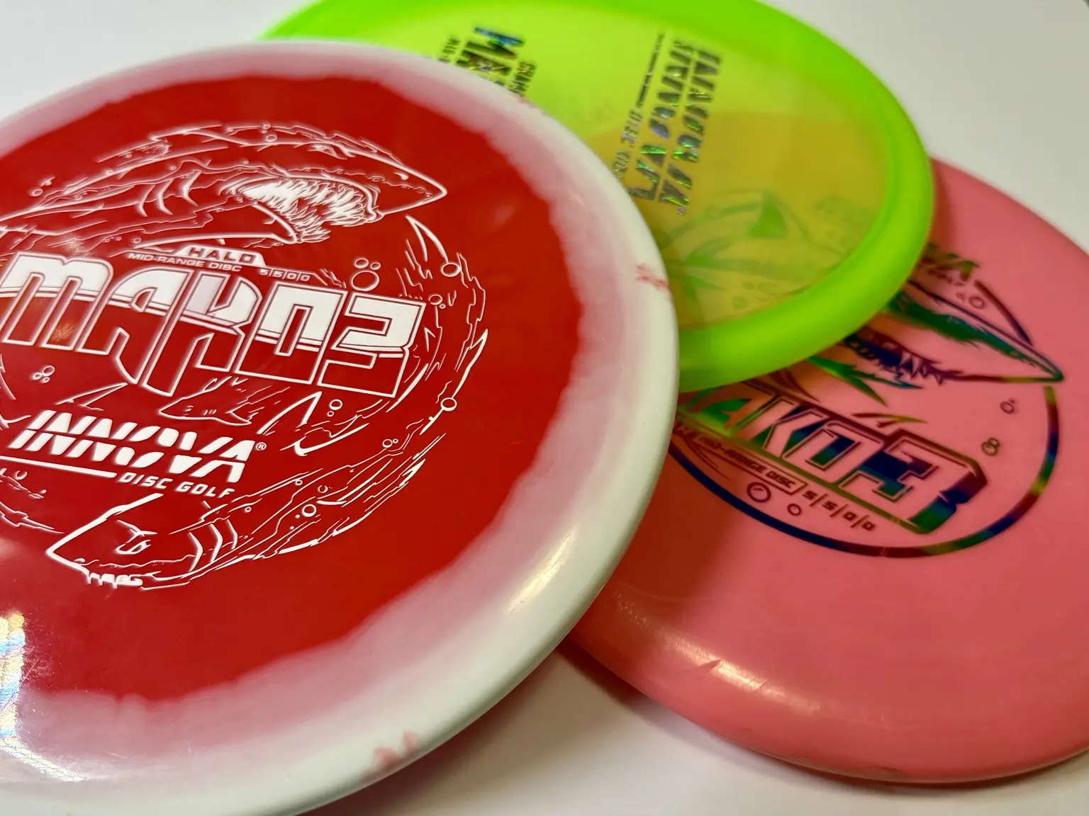 Colorful Innova disc golf discs showing several plastics and finishes